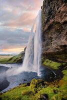 Stunning Seljalandsfoss Waterfall at Sunset, One of Icelands Most Popular and Breathtaking Natural Wonders photo