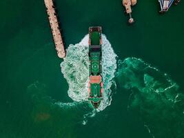 Aerial view of Empty cargo ship in ocean cian blue water photo