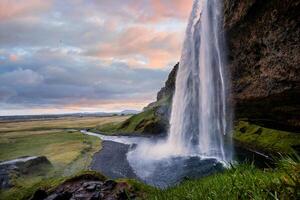 Stunning Seljalandsfoss Waterfall at Sunset, One of Icelands Most Popular and Breathtaking Natural Wonders photo