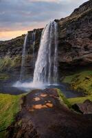 Stunning Seljalandsfoss Waterfall at Sunset, One of Icelands Most Popular and Breathtaking Natural Wonders photo