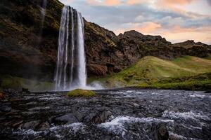 Stunning Seljalandsfoss Waterfall at Sunset, One of Icelands Most Popular and Breathtaking Natural Wonders photo