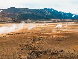 Aerial view of Hverir Geothermal Area in Iceland, capturing boiling mud pools, fumaroles, and the dramatic landscape of this geothermal hotspot near Lake Myvatn. photo