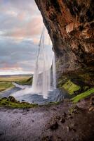 Stunning Seljalandsfoss Waterfall at Sunset, One of Icelands Most Popular and Breathtaking Natural Wonders photo