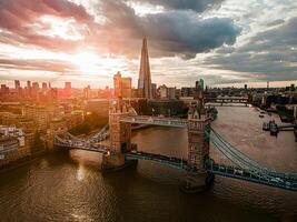 Aerial view to the Beautiful Tower Bridge and skyline of London, UK, during the sunset. photo