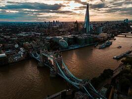 Aerial View of Tower Bridge and London Skyline at Sunset with Iconic Landmarks photo