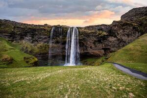 Majestic Seljalandsfoss Waterfall at Sunset in Iceland with Lush Green Landscape photo