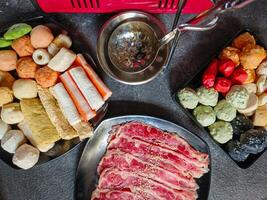 Ingredients for shabu-shabu dishes include sliced raw meat and processed ingredients for boiling which are based on seafood photo