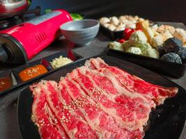 Ingredients for shabu-shabu dishes include sliced raw meat and processed ingredients for boiling which are based on seafood photo