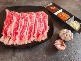 Ingredients for shabu-shabu dishes include sliced raw meat and processed ingredients for boiling which are based on seafood photo