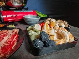 Ingredients for shabu-shabu dishes include sliced raw meat and processed ingredients for boiling which are based on seafood photo