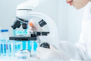 Scientist analyze biochemical samples in advanced scientific laboratory. Medical professional use microscope look microbiological developmental of viral. Biotechnology research in science lab. photo