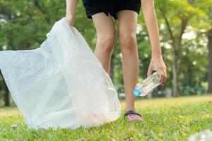 Save earth. Volunteer pick up trash garbage at the park and plastic bottles are difficult decompose prevent harm. Earth, Environment, Greening planet, reduce global warming, Save world ,pollution photo