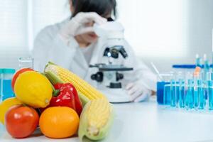 Scientist check chemical food residues in laboratory. Control experts inspect quality of fruits, vegetables. lab, hazards, ROHs, find prohibited substances, contaminate, Microscope, Microbiologist photo