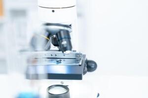 Scientist analyze biochemical samples in advanced scientific laboratory. Medical professional use microscope look microbiological developmental of viral. Biotechnology research in science lab. photo