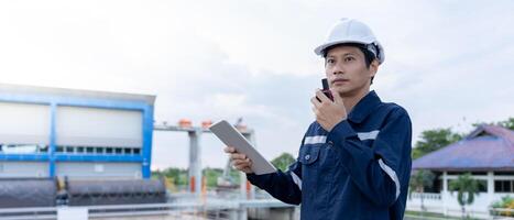 maintenance and inspector. Maintenance engineers are using walky talky to inform the results of inspection of buildings and structures. Irrigation engineers are exploring sluice systems photo