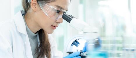 Scientist analyze biochemical samples in advanced scientific laboratory. Medical professional use microscope look microbiological developmental of viral. Biotechnology research in science lab. photo