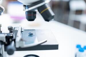 Scientist analyze biochemical samples in advanced scientific laboratory. Medical professional use microscope look microbiological developmental of viral. Biotechnology research in science lab. photo