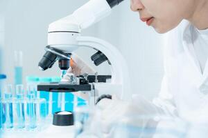Scientist analyze biochemical samples in advanced scientific laboratory. Medical professional use microscope look microbiological developmental of viral. Biotechnology research in science lab. photo