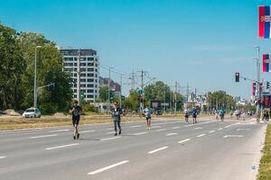 Belgrade, Serbia, April 28, 2024, 37th Belgrade Marathon Comtrade. People running a long distance marathon. Tired people runners looking for a second wind. photo