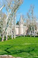 Istanbul, Turkiye, April 14, 2023, View of the main gate, walls and Topkapi Tower in Istanbul. Fragments of the wall and the main gate of Topkapi in Istanbul. photo