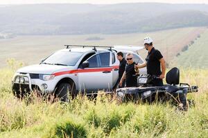 Rescuers on an ATV in the middle of the field, rescue vehicles photo