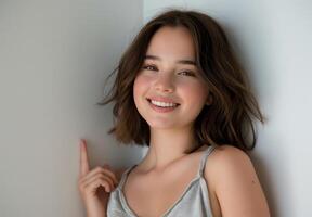 Smiling Young Woman in Casual Tank, Natural Light, Minimalist Background, Happy Expression, Relaxed Pose, Studio Shoot, Summer Season photo