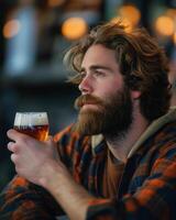 Contemplative Bearded Man Enjoying Craft Beer in Cozy Bar with Warm Lighting for Autumn Holidays, International Beer Day photo