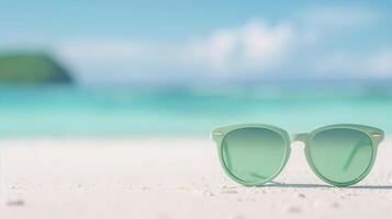 Stylish Green Sunglasses on Pristine Tropical Beach with Turquoise Sea Background and White Sand, Ideal for Summer Vacation, Coastal Getaway, or Resort Ad Campaigns photo