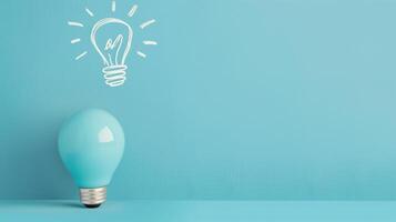 Blue Light Bulb With Chalk Drawing of Idea on Blue Background Inspiration Creativity Concept Innovation Stock Photo
