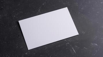 Blank White Card on Dark Textured Background for Mockups, Invitations, Greeting Cards, Business Branding, or Minimalist Designs photo
