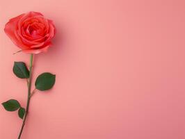 Elegant Single Red Rose on Pastel Coral Background With Green Leaves for Valentine's Day, Romantic Celebrations, Floral Arrangements, and Botanical Themes - Minimalistic Flower Photography photo