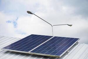 Photovoltaic or solar panels on roof for generating electricity for lamps. Concept using green and clean energy for environment. Renewable energy, Natural power from sunlight to reduce global warming photo