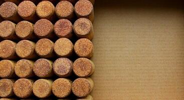 Concept for postcard or background of wine corks on a cardboard with copy space photo