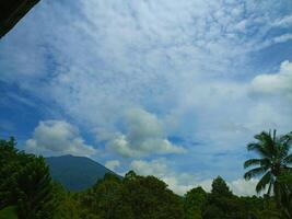 mountain view with white clouds on a sunny day photo
