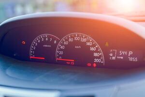 Close-up of a speedometer on a car dashboard showing speed with black and red details photo