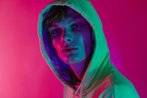 Modern portrait of Fashion Male Model in Neon Green Hoodie with Neon pink Background Chic and Trendy Style photo