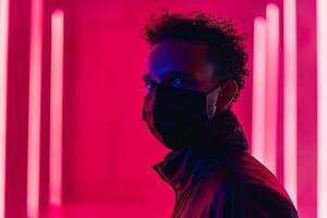 Fashionable Male Model in Burgundy Face Mask with Neon pink Background Stylish Lifestyle portrait photo