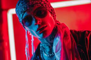 Handsome Fashion Male Model in Luxurious Bandana with Neon Red Modern Males portrait Featuring Trendy Neon Red Background photo