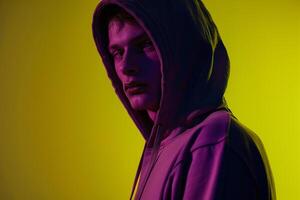 Fashion Male Model in Dark purple Hoodie with Neon Yellow Background Fashionable and Trendy Apparel Lifestyle portrait photo