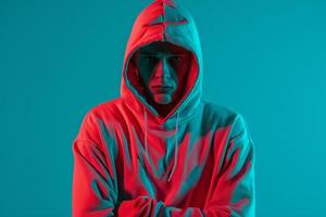 Stylish Male Model in Neon Red Hoodie with Neon Teal Background Dynamic and Bold Males portrait Featuring Contemporary Urban Fashion photo