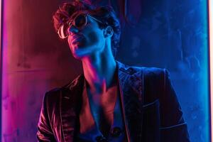 Stylish Handsome Fashion Model in a Velvet Suit featuring a Neon Blue backdrop showcasing a modern Males fashion portrait with a vibrant lifestyle setting photo