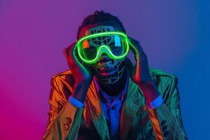 Handsome Model in Casual Blazer with Neon Green Ski Mask and Neon Blue Background Trendy portrait photo