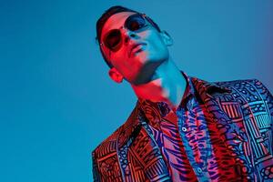Handsome Fashion Model in patterned Jacket with Neon Blue Background Stylish Lifestyle Focus photo