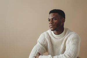 Trendy Male Model in Comfortable Sweater Soft Beige Background Relaxed portrait Modern and Cozy Males Fashion photo