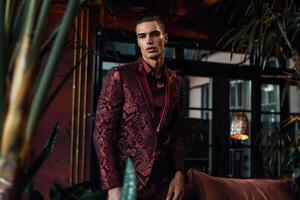 Trendy Male Fashion Model in a Brocade Suit with Deep Burgundy perfect for High Class Lifestyle portraits and Luxe Maleswear Style photo