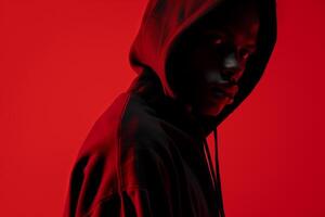Fashion Model in Deep Ruby Red Hoodie Trendy Males portrait Modern Fashion Lifestyle Stylish Casual Outfit with Ruby Red Background photo