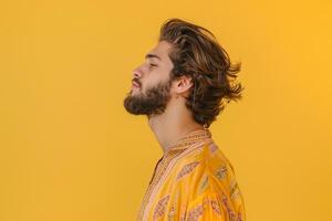 Males fashion with a flowing blouse and buttery yellow background presenting a bright and gentle lifestyle in a modern soft touch portrait photo