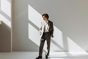 Classy male fashion model in a well tailored suit with a frosted white background emphasizing Males lifestyle portrait fashion and elegant male dress photo