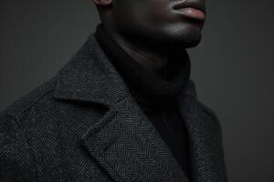 Trendy male model in a tailored jacket with a charcoal background chic portrait highlighting modern and stylish Males outerwear photo