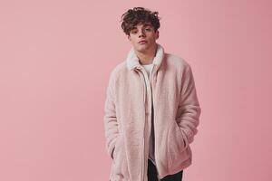 Trendy male fashion model in a zip up jacket with a pastel pink background emphasizing modern lifestyle and fashionable portrait photo